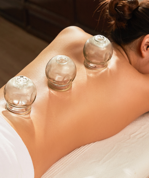 A woman getting a back massage at a spa