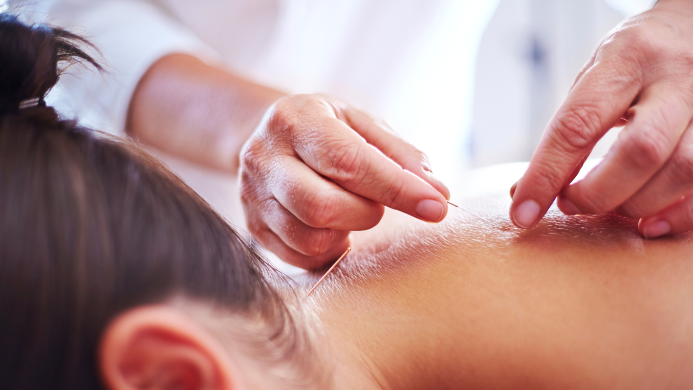 A woman getting a back massage at a spa