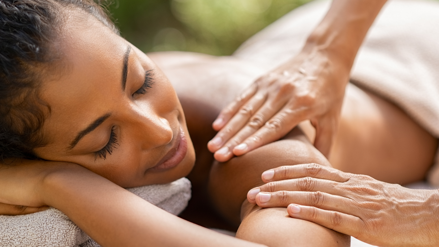 A woman getting a back massage at a spa